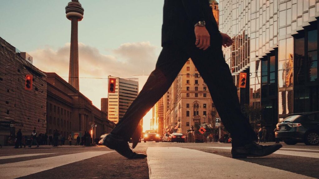 Closeup photo of a businessman crossing a street in the city of Toronto