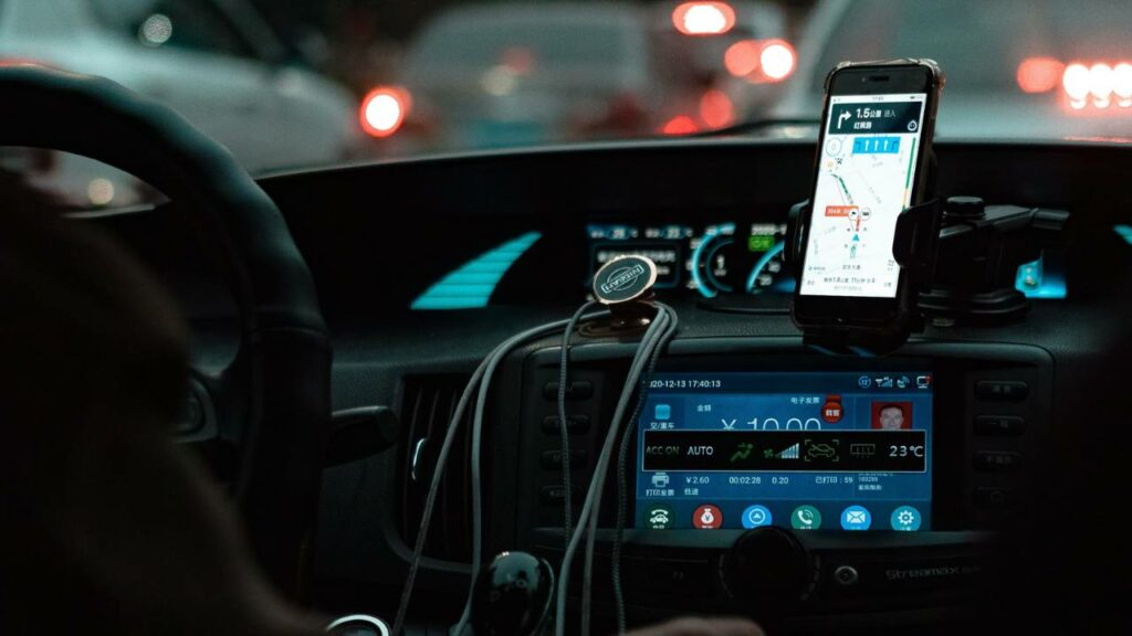 A modern automobile dashboard with a smartphone