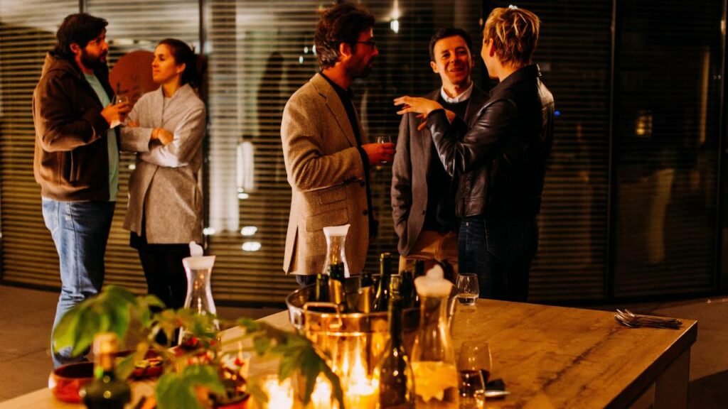 Business people conversing and drinking wine at an event