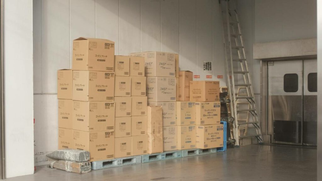 Dozens of cardboard boxes stored in a hangar
